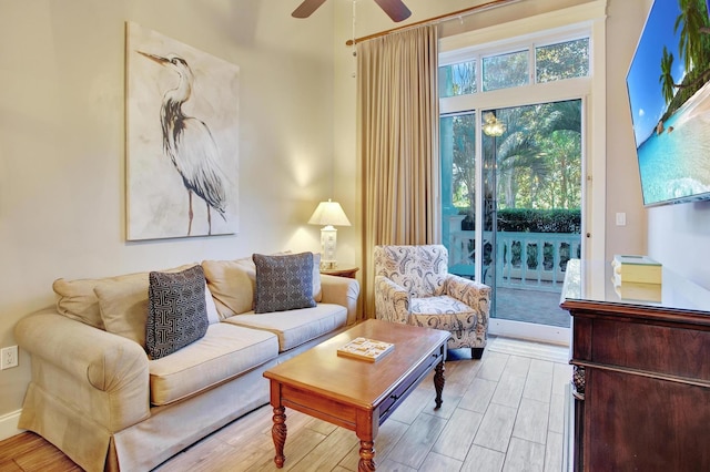 living room with ceiling fan and light hardwood / wood-style floors