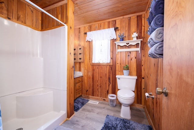 bathroom with hardwood / wood-style flooring, walk in shower, wood ceiling, wooden walls, and toilet