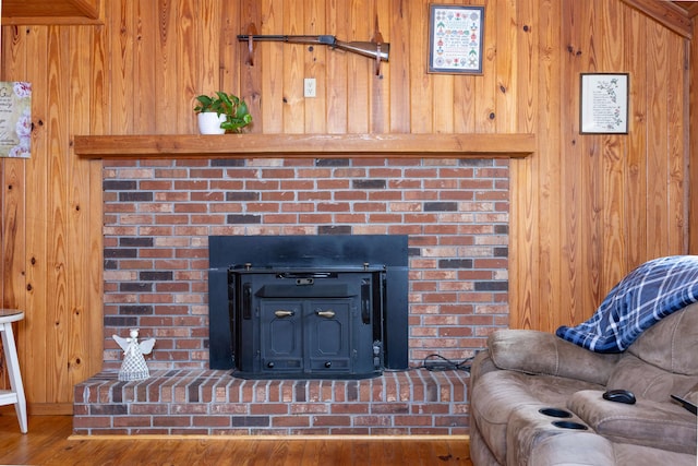 room details with wood walls and hardwood / wood-style flooring