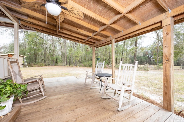 wooden deck with ceiling fan and a lawn