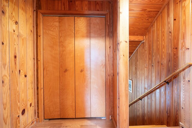 interior space featuring wooden walls and light wood-type flooring