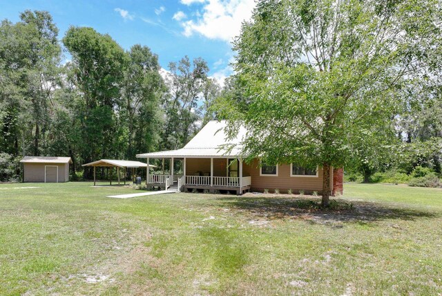 view of front of home with a porch, a front lawn, and a storage unit