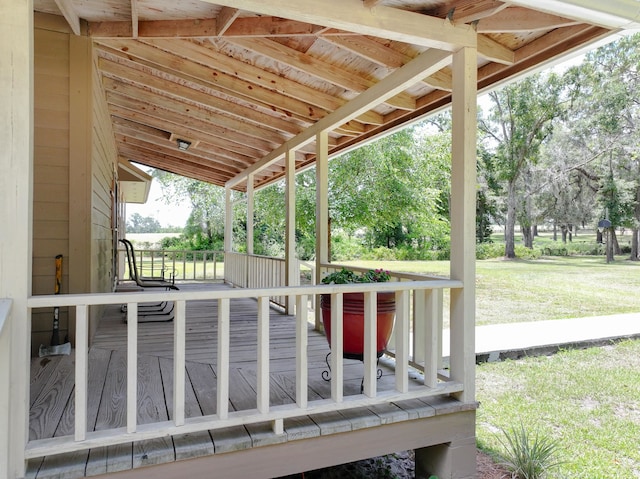 wooden terrace featuring a yard