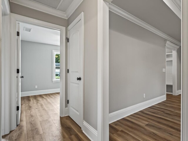 hallway featuring crown molding and dark wood-type flooring