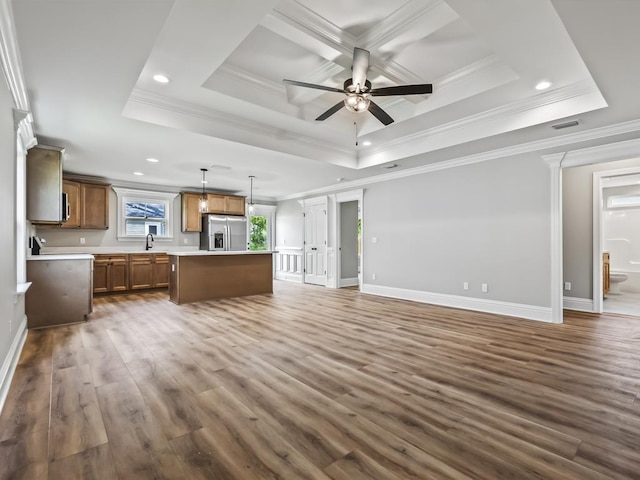 kitchen featuring a kitchen island, dark hardwood / wood-style floors, decorative light fixtures, a raised ceiling, and stainless steel refrigerator with ice dispenser