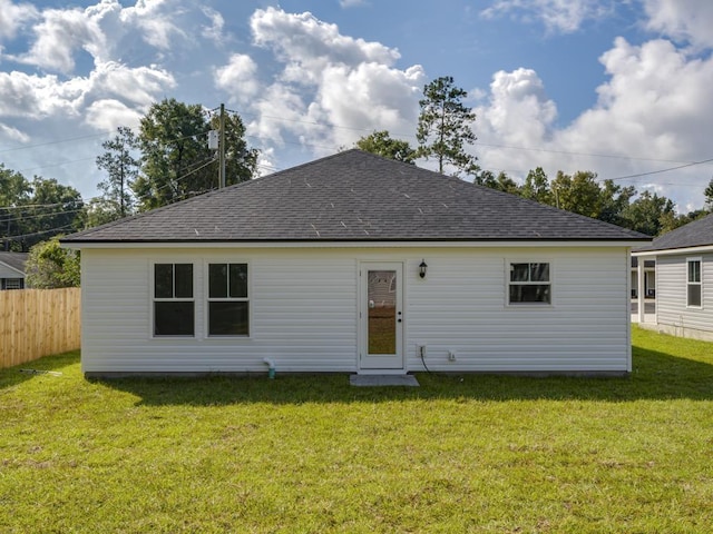 back of property with a lawn