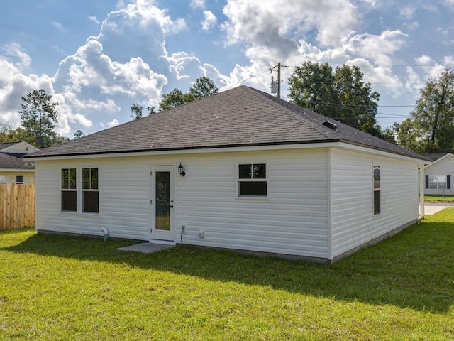 rear view of house with a lawn