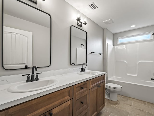 full bathroom with bathtub / shower combination, vanity, and toilet