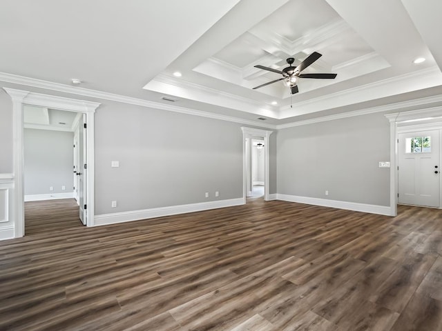 unfurnished room featuring dark hardwood / wood-style floors, ceiling fan, ornamental molding, and a tray ceiling