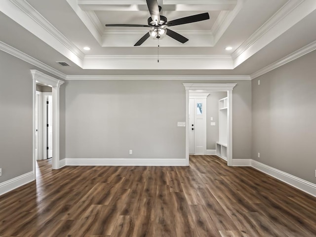 spare room featuring ornate columns, ornamental molding, dark hardwood / wood-style floors, a tray ceiling, and ceiling fan