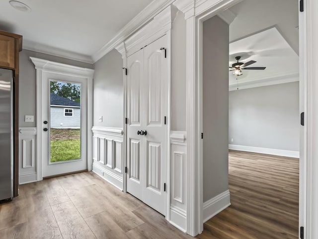 mudroom with ceiling fan, ornamental molding, and light hardwood / wood-style flooring