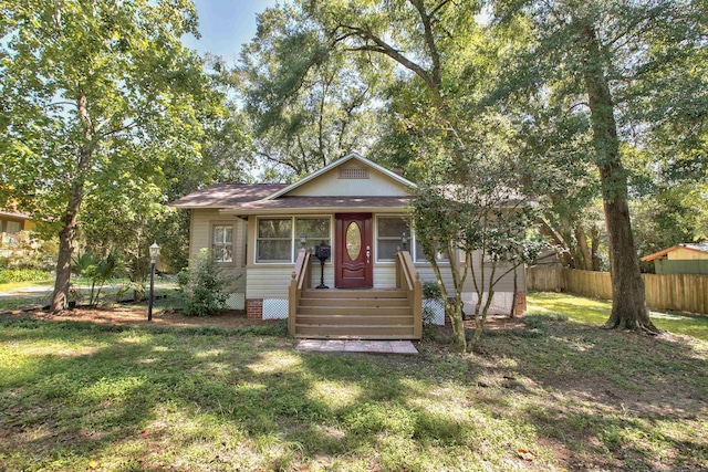 bungalow-style home with a front lawn