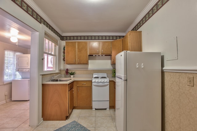 837 E Park Ave, Tallahassee, FL 32301 - kitchen featuring white appliances, sink, ornamental molding, light tile patterned flooring, and stacked washer / dryer