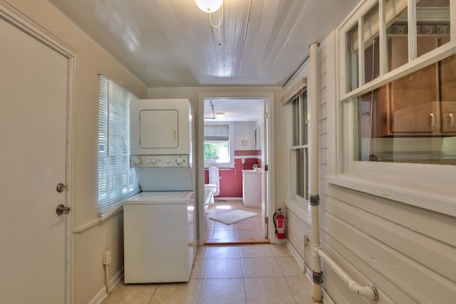 837 E Park Ave, Tallahassee, FL 32301 - laundry area with stacked washer / dryer and light tile patterned flooring