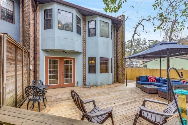 deck featuring a gazebo, outdoor lounge area, and french doors