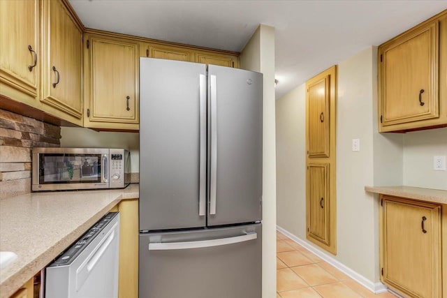 kitchen featuring stainless steel appliances and light tile patterned floors