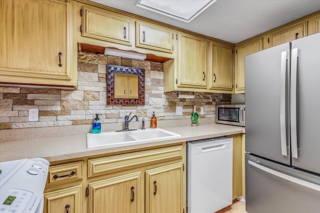 kitchen featuring tasteful backsplash, appliances with stainless steel finishes, and sink