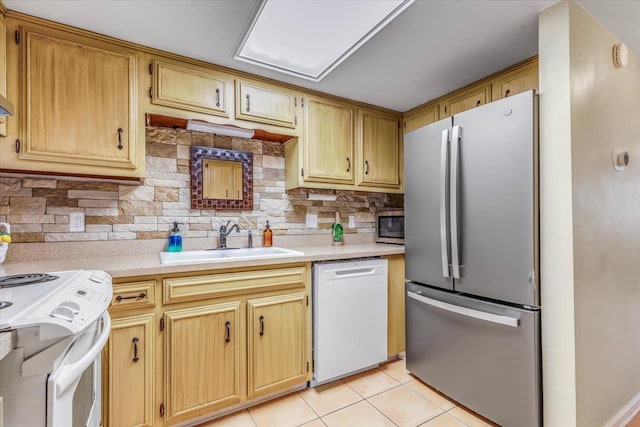 kitchen featuring light tile patterned flooring, appliances with stainless steel finishes, sink, and tasteful backsplash