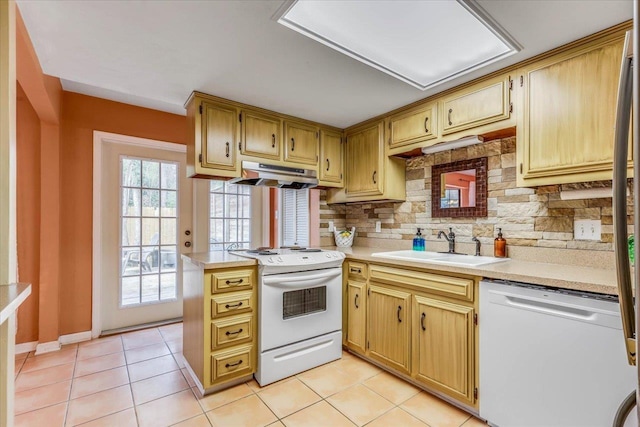 kitchen with sink, light tile patterned floors, white appliances, backsplash, and kitchen peninsula