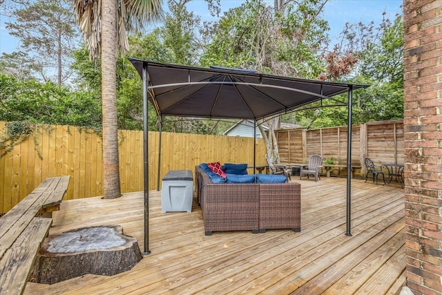 wooden terrace with a gazebo and an outdoor hangout area