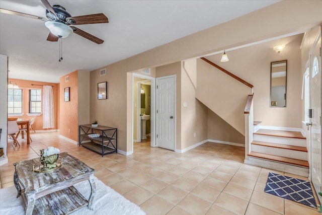 tiled living room featuring ceiling fan