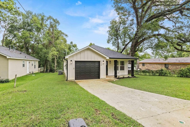 2224 Keith St, Tallahassee, FL 32310 - view of front of home featuring board and batten siding, a front lawn, driveway, and a garage