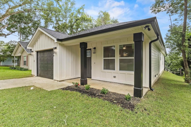 2224 Keith St, Tallahassee, FL 32310 - ranch-style home featuring board and batten siding, an attached garage, driveway, and a front lawn