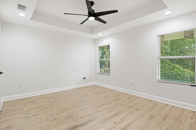 2224 Keith St, Tallahassee, FL 32310 - empty room featuring light wood-style floors, a raised ceiling, recessed lighting, and a ceiling fan
