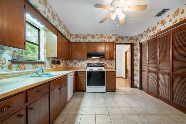 2104 Alton Rd, Tallahassee, FL 32303 - kitchen featuring electric range oven, dishwasher, under cabinet range hood, a sink, and wallpapered walls