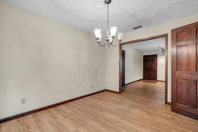 2104 Alton Rd, Tallahassee, FL 32303 - unfurnished room featuring a chandelier, light wood finished floors, and baseboards