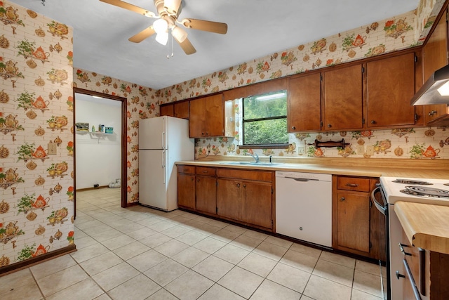 2104 Alton Rd, Tallahassee, FL 32303 - kitchen featuring white appliances, wallpapered walls, light countertops, brown cabinetry, and a ceiling fan