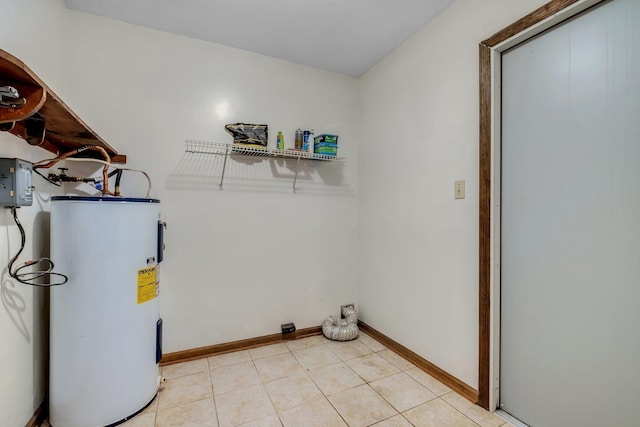 2104 Alton Rd, Tallahassee, FL 32303 - laundry room with electric water heater, baseboards, and light tile patterned floors