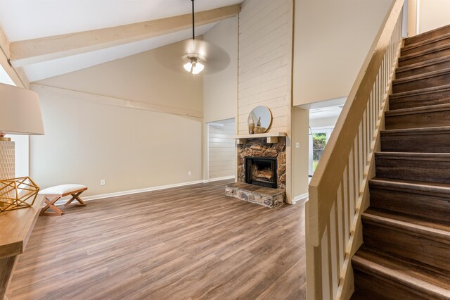 2053 Ted Hines Dr, Tallahassee, FL 32308 - stairway with a fireplace, wood finished floors, high vaulted ceiling, beam ceiling, and a ceiling fan