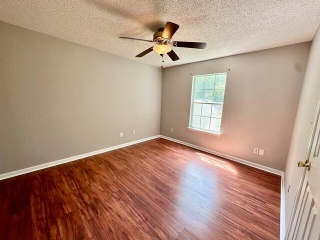 unfurnished room featuring hardwood / wood-style floors, ceiling fan, and a textured ceiling