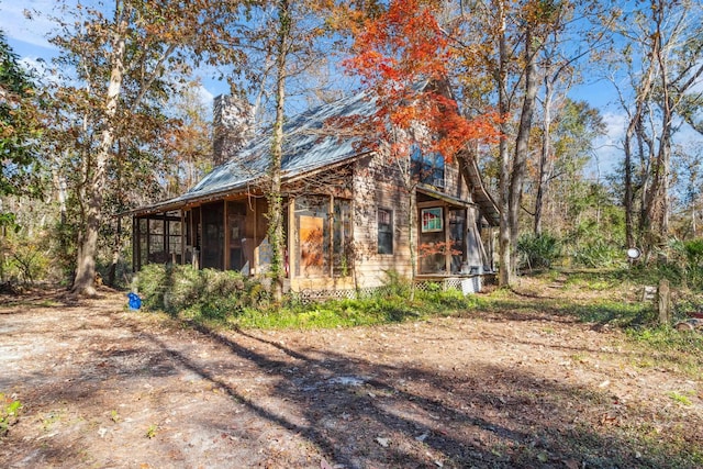 view of side of property with a sunroom