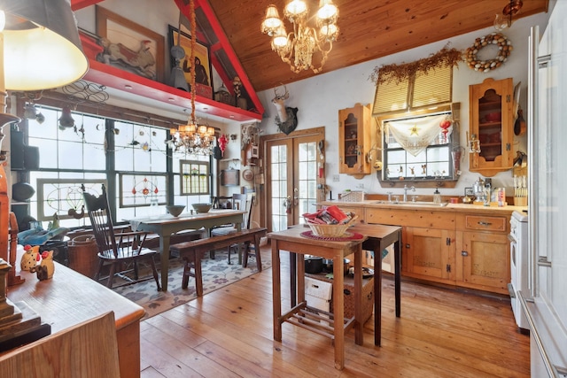 dining room with wooden ceiling, an inviting chandelier, sink, light hardwood / wood-style flooring, and vaulted ceiling