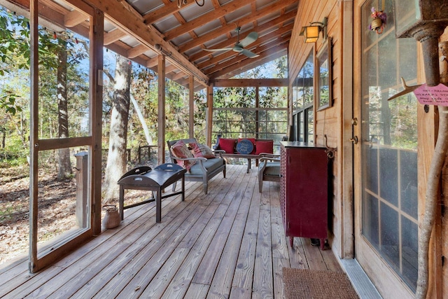 unfurnished sunroom with ceiling fan and lofted ceiling