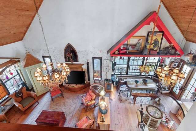 living room with wood-type flooring, high vaulted ceiling, an inviting chandelier, and wooden ceiling