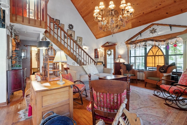 living room featuring light wood-type flooring, an inviting chandelier, high vaulted ceiling, and wooden ceiling