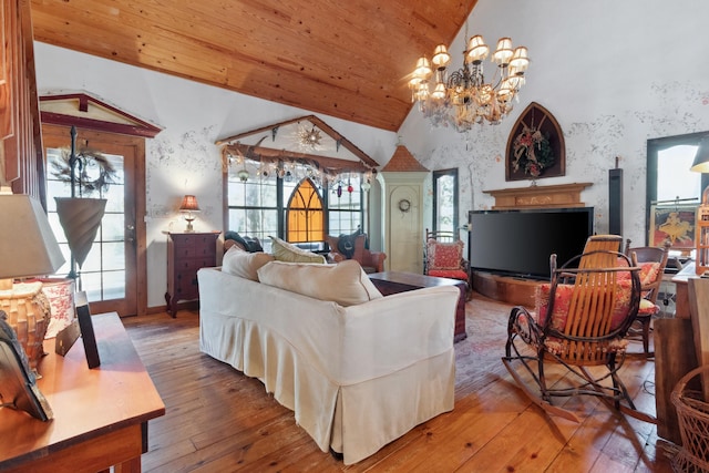 living room with hardwood / wood-style flooring, high vaulted ceiling, a notable chandelier, and wood ceiling