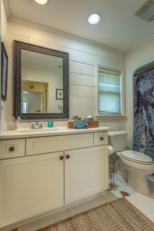 bathroom featuring ornamental molding, tile patterned floors, and toilet