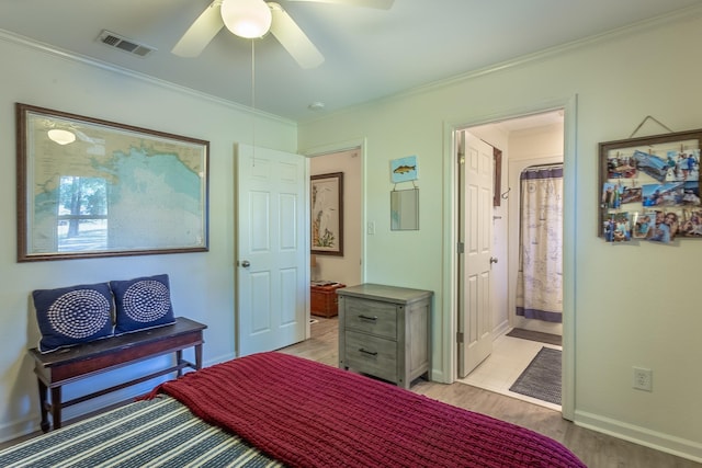 bedroom with crown molding, ceiling fan, light hardwood / wood-style floors, and ensuite bath