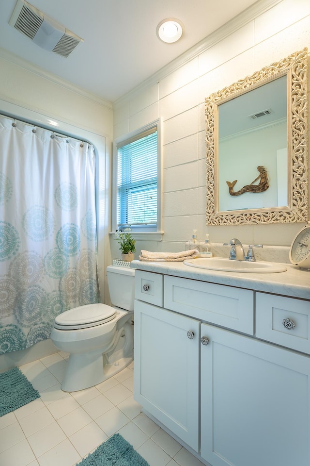 bathroom with ornamental molding, vanity, tile patterned floors, and toilet