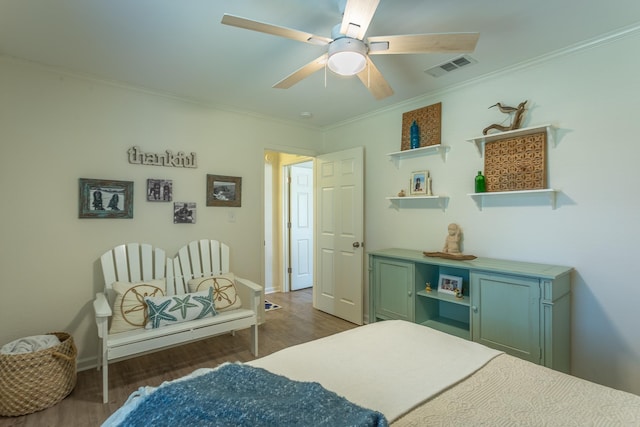 bedroom with ceiling fan, ornamental molding, and dark hardwood / wood-style floors