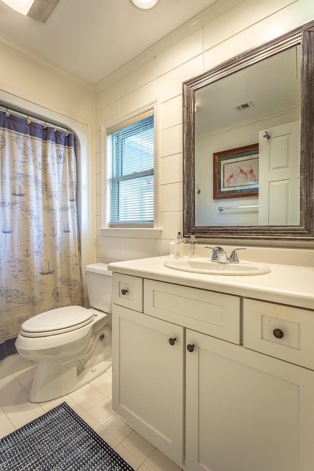 bathroom featuring vanity, tile patterned floors, ornamental molding, and toilet