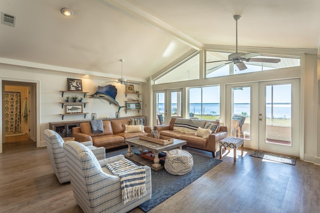 living room featuring french doors, a water view, wood-type flooring, ceiling fan, and beam ceiling