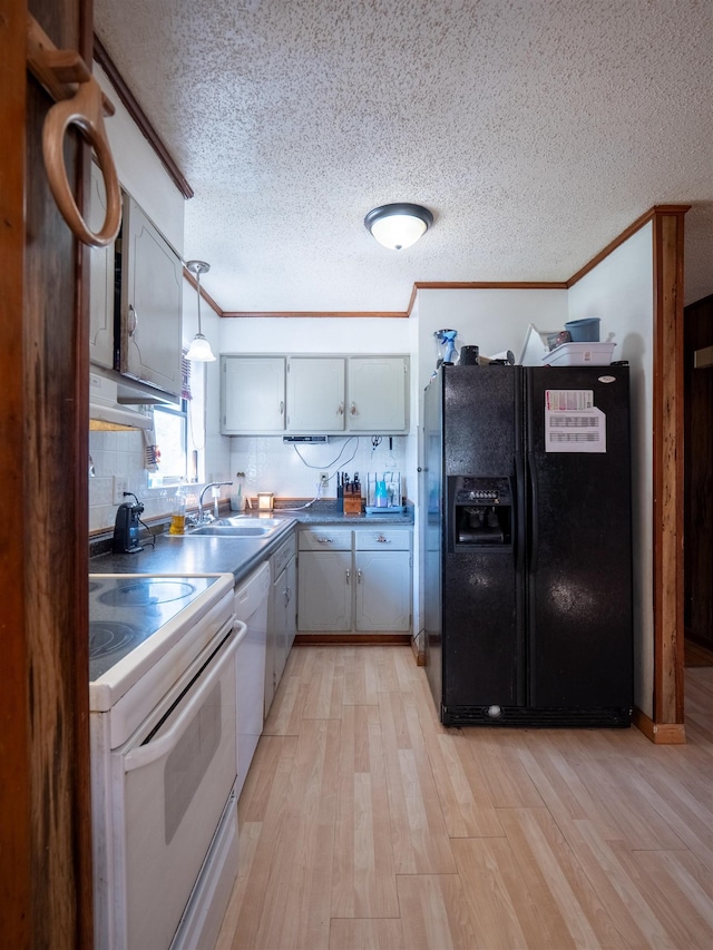 kitchen featuring white appliances, ornamental molding, decorative light fixtures, light wood-type flooring, and a sink