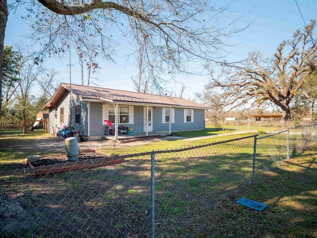 view of front of property with a fenced front yard and a front lawn