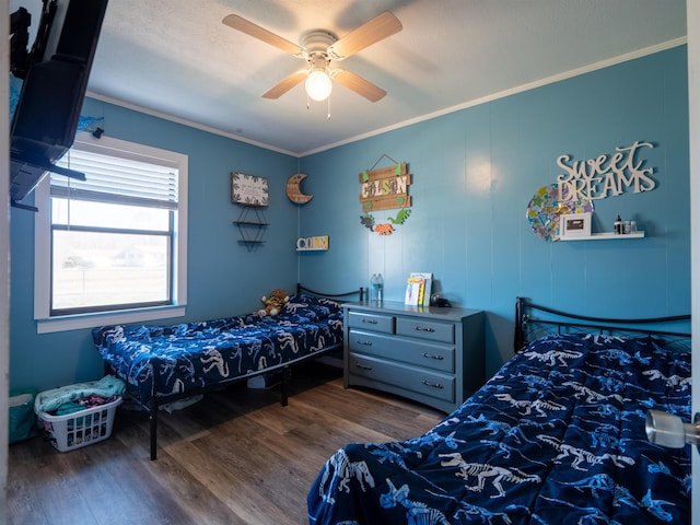 bedroom with ceiling fan, ornamental molding, and dark wood finished floors