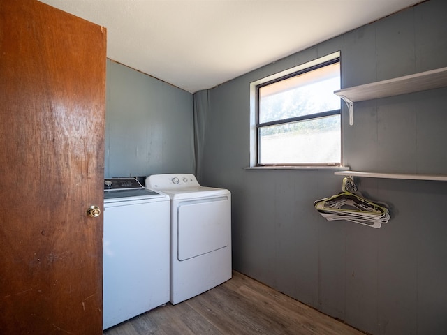 laundry room with laundry area, light wood-style flooring, and washer and dryer